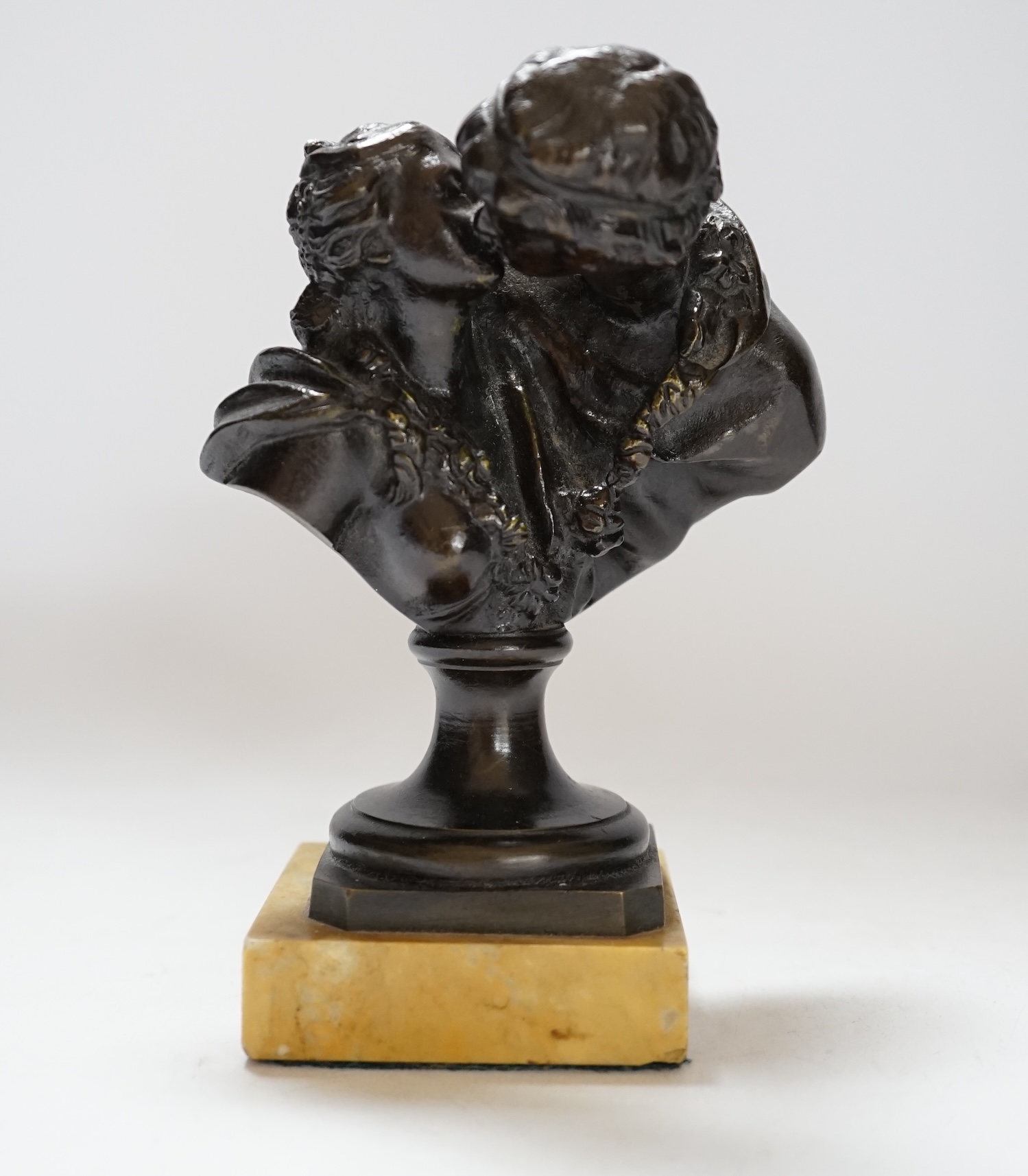 After Jean-Antoine Houdon (1741-1828), a bronze group, 'Le Baiser Donne' [‘The Kiss Bestowed’] on marble base, 16cm high